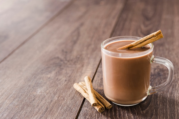 Taza de chocolate caliente con canela y espacio de copia