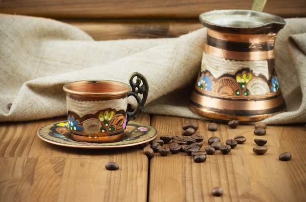 Taza de cobre turca con café turco y granos de café.