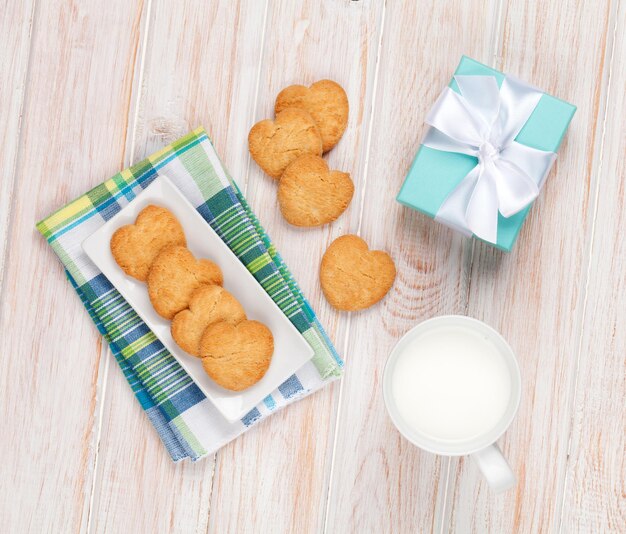 Taza de leche con forma de corazón de galletas y caja de regalo.