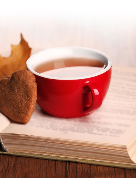 Taza de té con decoración de otoño en mesa de madera