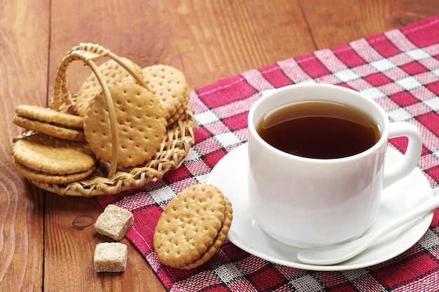 Taza de té con galletas en una mesa de madera