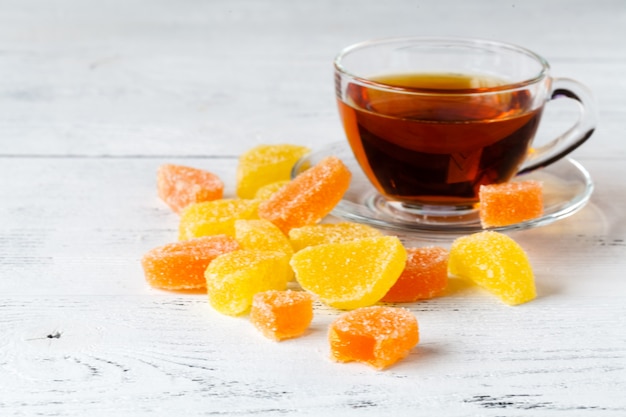 Taza de té con mermelada de naranja en la mesa, concepto de desayuno