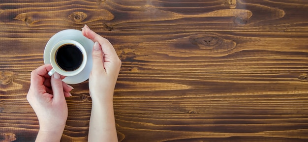 Tazas con un café en manos de hombres y mujeres.