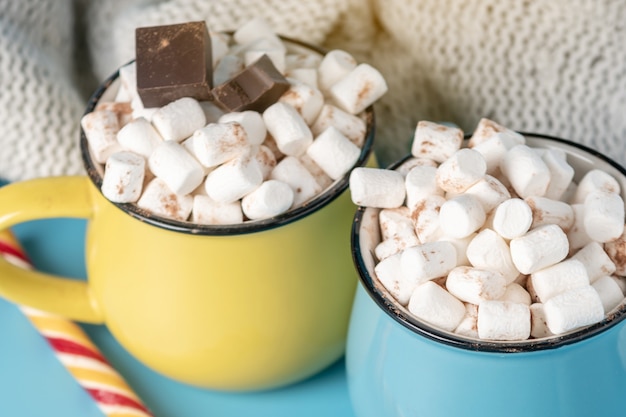 Tazas de chocolate caliente con malvaviscos encima y pegar una paleta.