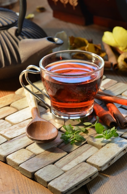 Tazas de té rojo acompañadas de incienso, canela y velas.