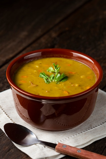 Tazón de sopa de guisantes con sopa de guisantes en la mesa