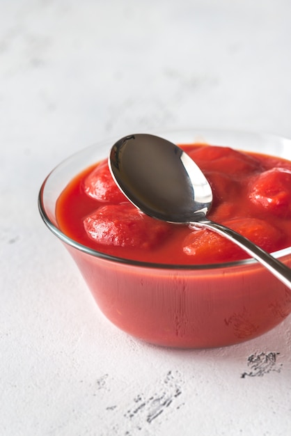 Foto tazón de tomates enlatados