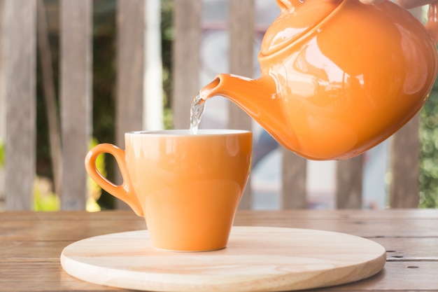 El té caliente se vierte de la tetera en una taza