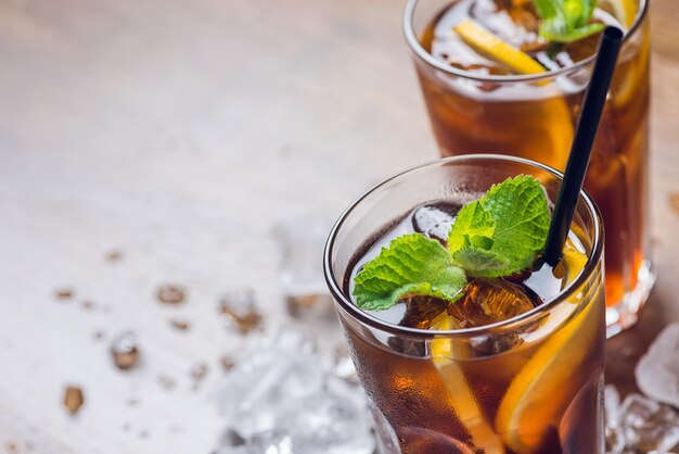 Té helado tradicional enfriado con menta limón y hielo sobre mesa rústica