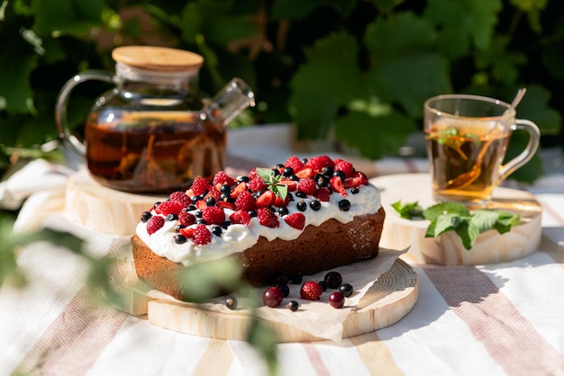 Tea Party mit Cupcake an der frischen Luft rustikales Frühstück hausgemachter Kuchen mit Beeren und Schlagsahne