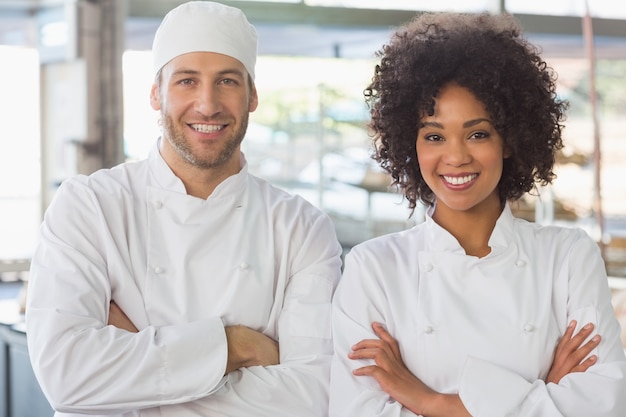 Team of bakers smiling at camera