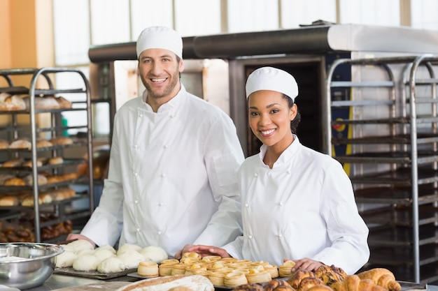 Team of bakers smiling at camera