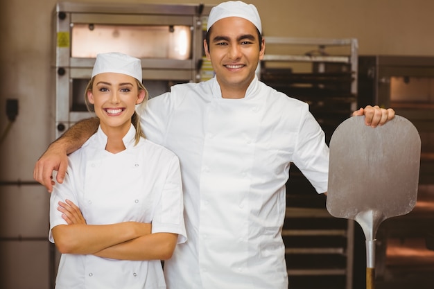 Team of bakers smiling at camera