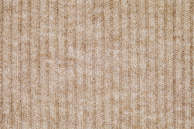 tecido bege de close-up tricotado a partir de fios de fiação papel de parede de fundo padrão de textura uniforme