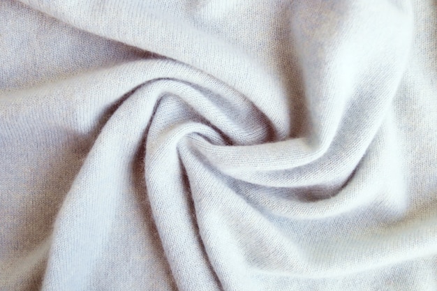 Tecido de cashmere bege com textura de lã natural drapeado vista superior