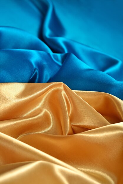 Tecido de cetim dourado e azul natural como textura de fundo