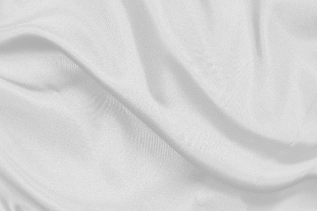 Tecido de seda branca elegante e suave ou textura de pano de luxo acetinado pode ser usado como fundo de casamento para design abstrato luxuoso de cortinas