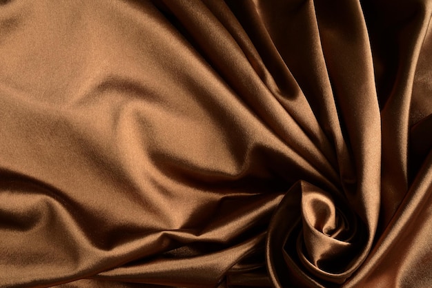 Tecido de seda ou cetim com cortinas cortinas ou cortinas cor castanha Textura de tecido pano castanho escuro