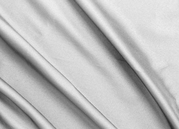 Tecido de seda preto suave e elegante ou textura de tecido de luxo acetinado para fundo abstrato