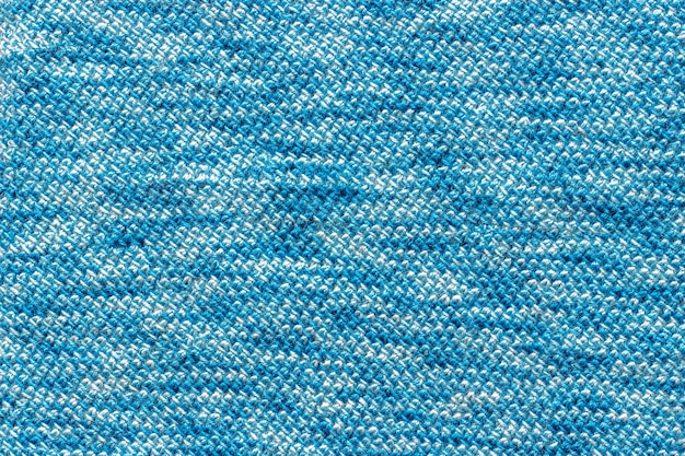 Tecido de textura amarrado com fio azul.