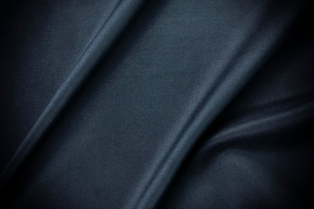 Tecido liso e azul escuro elegante seda ou cetim e textura de pano de luxo
