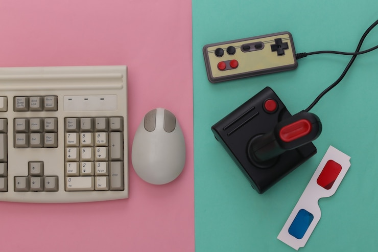 Foto teclado antiguo, gafas 3d y joysticks sobre fondo azul rosa. juegos retro. videojuego estéreo. años 80. vista superior. endecha plana