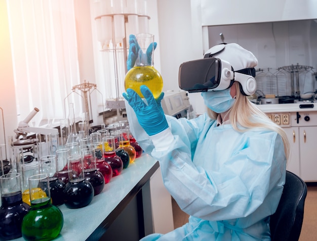 Técnico científico en gafas de realidad virtual examina la droga en el laboratorio.
