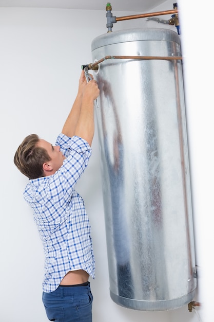 Técnico que atiende un calentador de agua