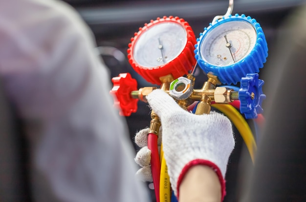 Técnico que controla el sistema de aire acondicionado del coche