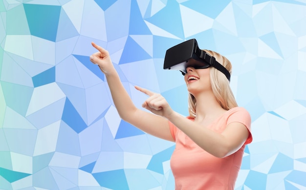 tecnología, realidad virtual, entretenimiento y concepto de personas - mujer joven feliz con auriculares de realidad virtual o anteojos 3d fondo azul de textura polivinílica baja