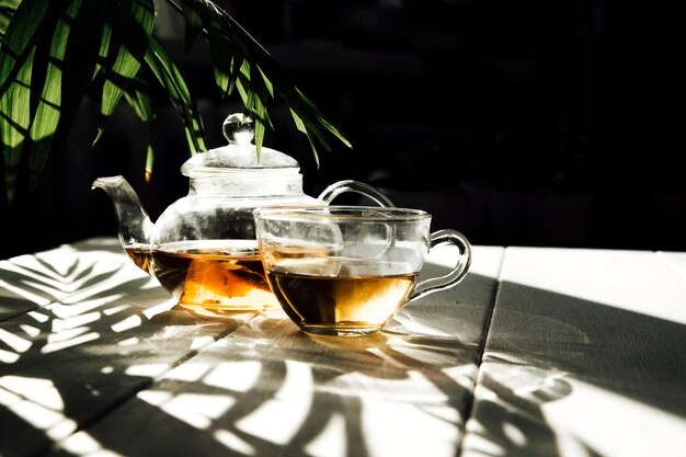 Tee in einer Teekanne in der Sonne auf Hintergrundnahaufnahme
