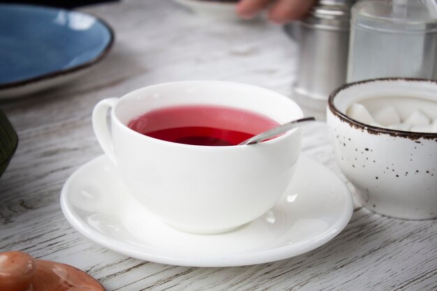 Tee in einer weißen Tasse auf dem Tisch