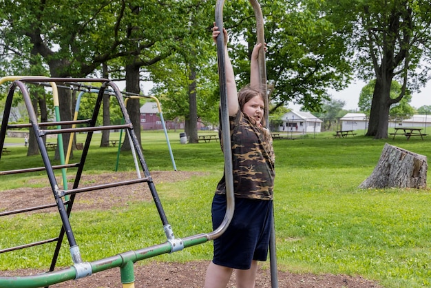 Teenager klettern im Sommer auf Spielplatz.