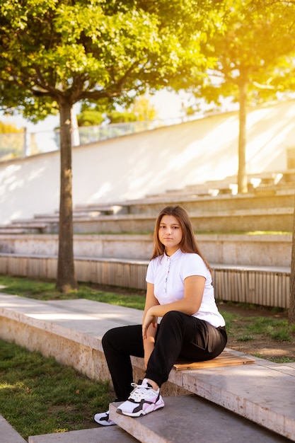 Teenager-Mädchen sitzt auf einer Schulbank