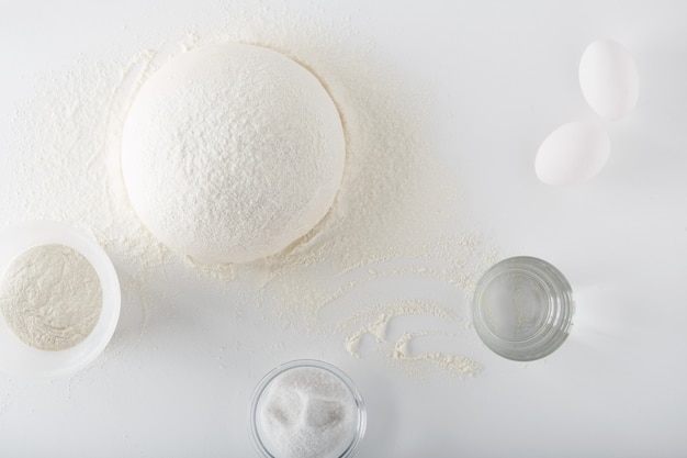 Teig zum Backen von Brot und Pizza auf einem weißen Tisch