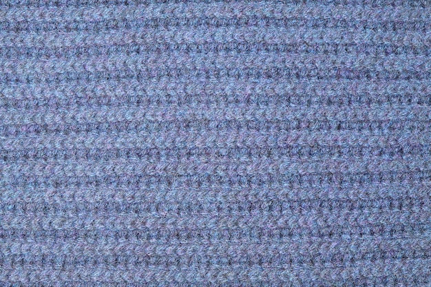 Tejer textura de tejido de punto de lana azul con patrón como fondo