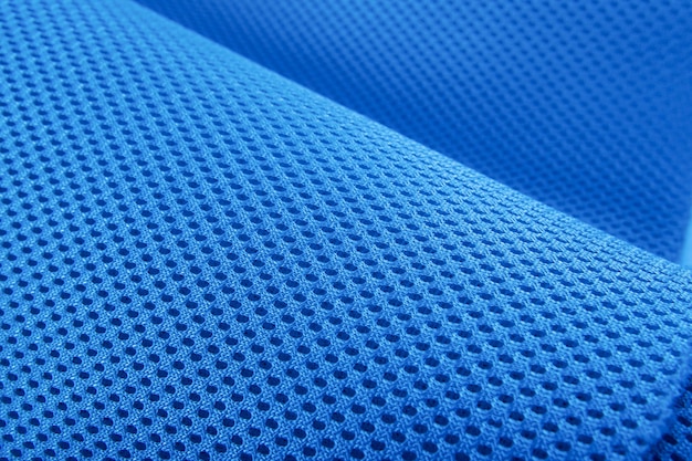 Tejido azul áspero textura tela de algodón tejido de punto moderno impermeable materiales flexibles de control de temperatura textil multifuncional inteligente de primer plano enfoque selectivo no se desgarra