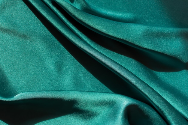 Tejido satinado azulverde Tejido de seda suave cortado en la mesa