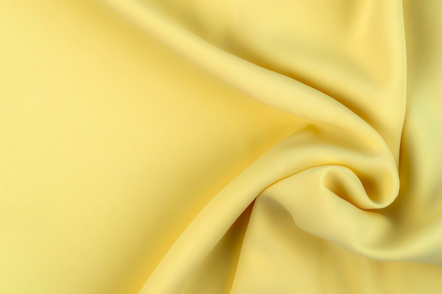 Foto tejido de tela de color amarillo con textura de poliéster y fondo textil