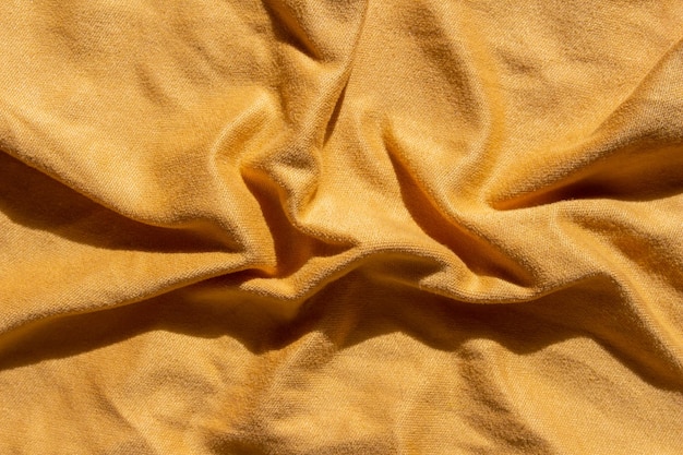 Una tela amarilla con una tela suave que se dobla por la mitad.