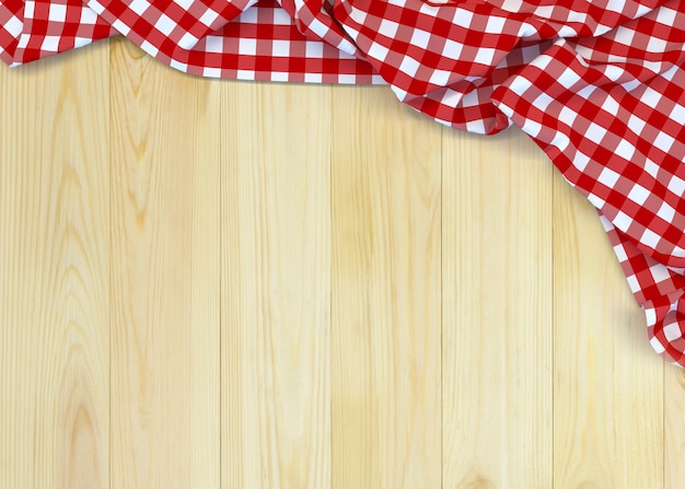 Tela a cuadros roja y blanca en la mesa de madera