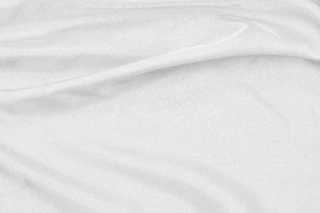 La tela de seda blanca elegante suave o la textura de tela de lujo satinada se pueden utilizar como fondo de boda. para cortinas de lujoso diseño abstracto