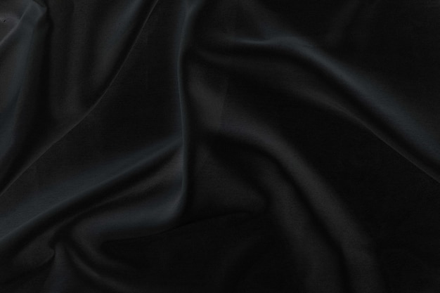 Tela de seda negra elegante y suave o textura de tela satinada de lujo para un fondo abstracto
