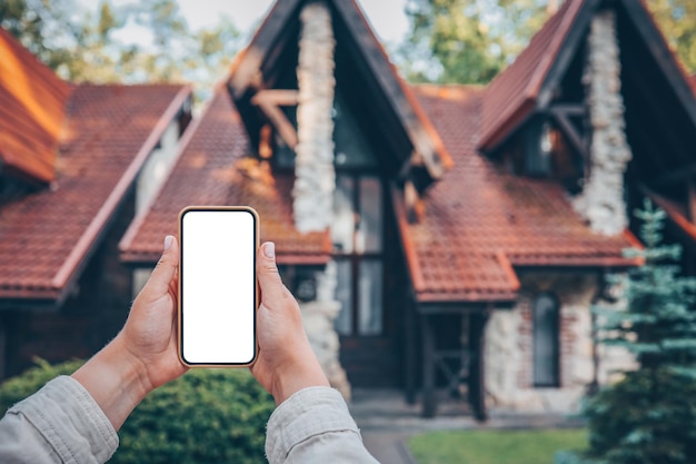 Telefon mit isoliertem Bildschirm auf dem Hintergrund der Hütte