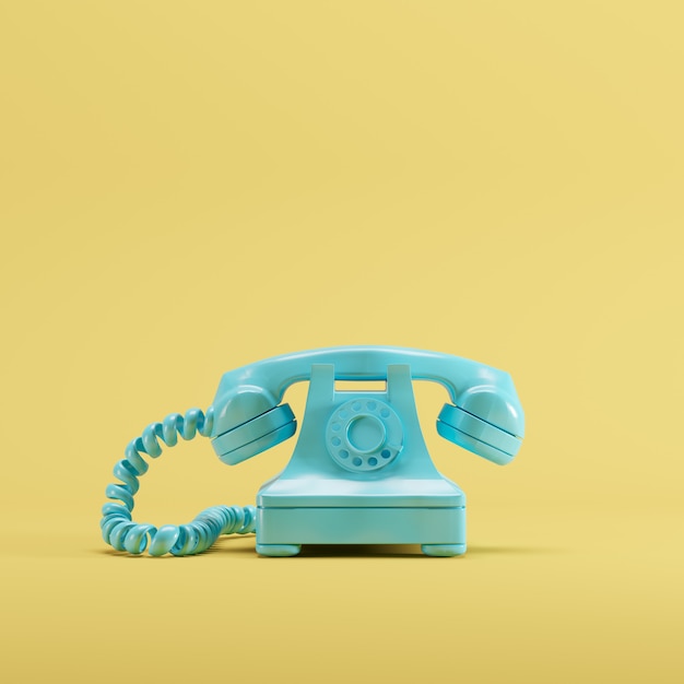 Telefone azul do vintage no fundo amarelo da cor pastel. conceito de ideia mínima.