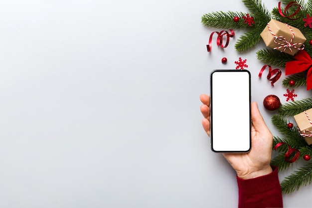 Telefone digital simulado com decorações de Natal rústicas para vista superior de apresentação de aplicativos com espaço vazio para você projetar Conceito de compras on-line de Natal Tablet com espaço de cópia em fundo colorido