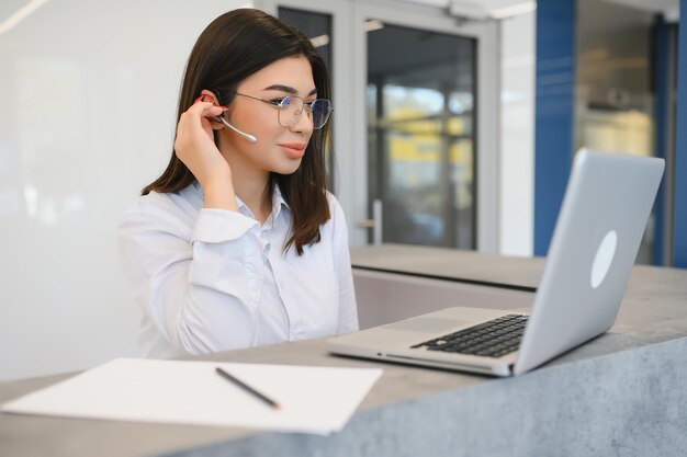 Telefonistin im Headset am Arbeitsplatz unterstützen