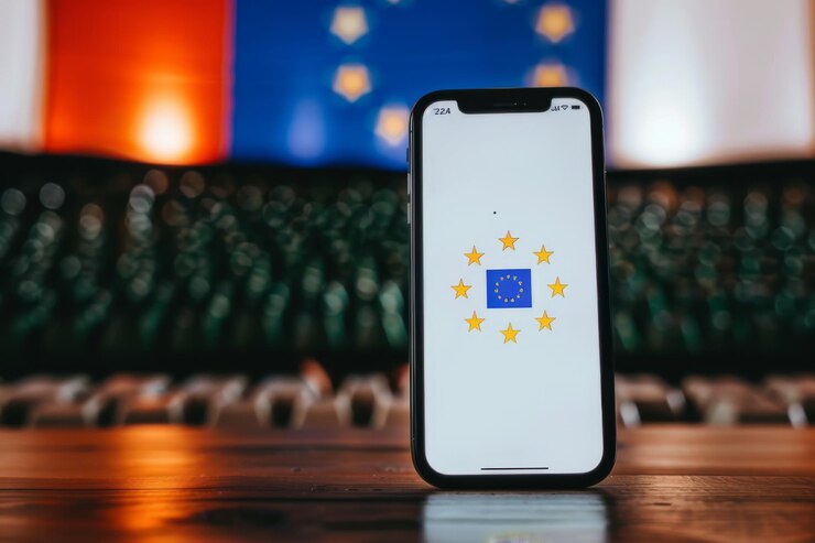 Un teléfono inteligente con un sistema de calificación de estrellas en la pantalla al lado de una pelota de fútbol que sugiere una aplicación deportiva o comentarios