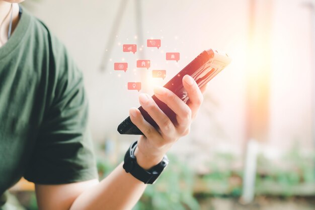 Foto teléfono móvil negro en la mano con icono rojo de aplicaciones de marketing en internet e-learning