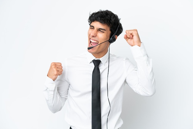 Telemarketing-Mann, der mit einem Headset arbeitet, das auf weißem Hintergrund isoliert ist und einen Sieg feiert?